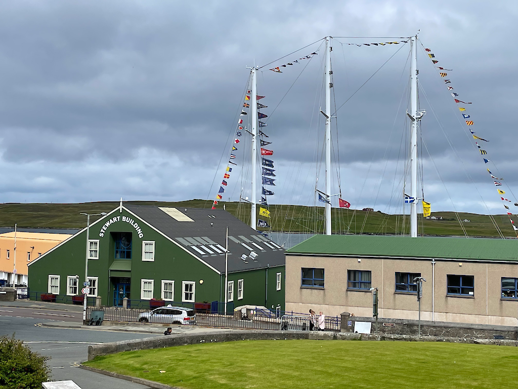 In the heart of the Tall Ships – the masts of the gaff schooner, Eendracht, tower over the Stewart Building, where NB Communications offices are located.